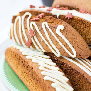 gingerbread biscotti with white chocolate drizzle and gingerbread sprinkles.