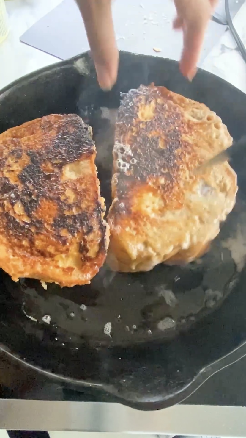 Frying french toast sandwiches in a cast iron skillet.