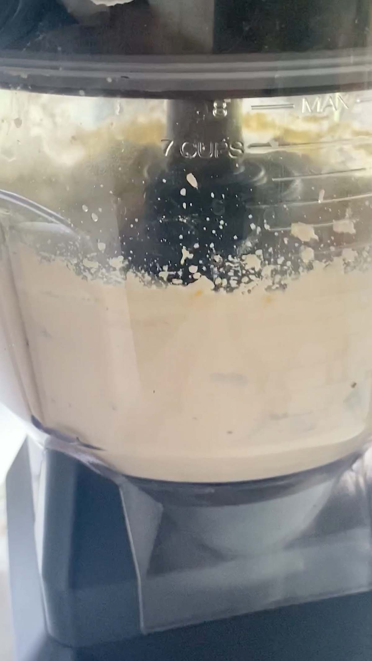 Whipping ricotta in a food processor jug.