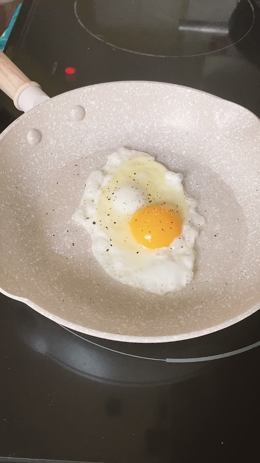 Frying an egg in a skillet.
