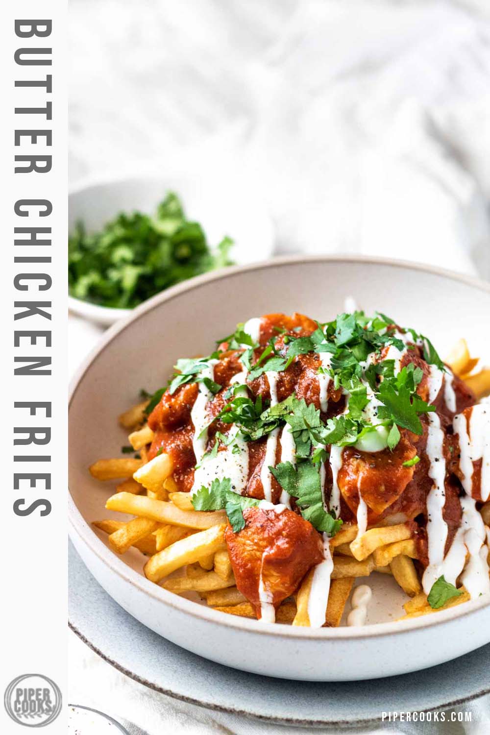 Fries with butter chicken sauce on top with text title.