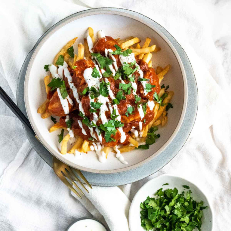 Fries with butter chicken sauce on top.
