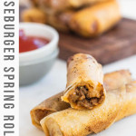Cheeseburger spring rolls cut in half to show the filling with a text title.