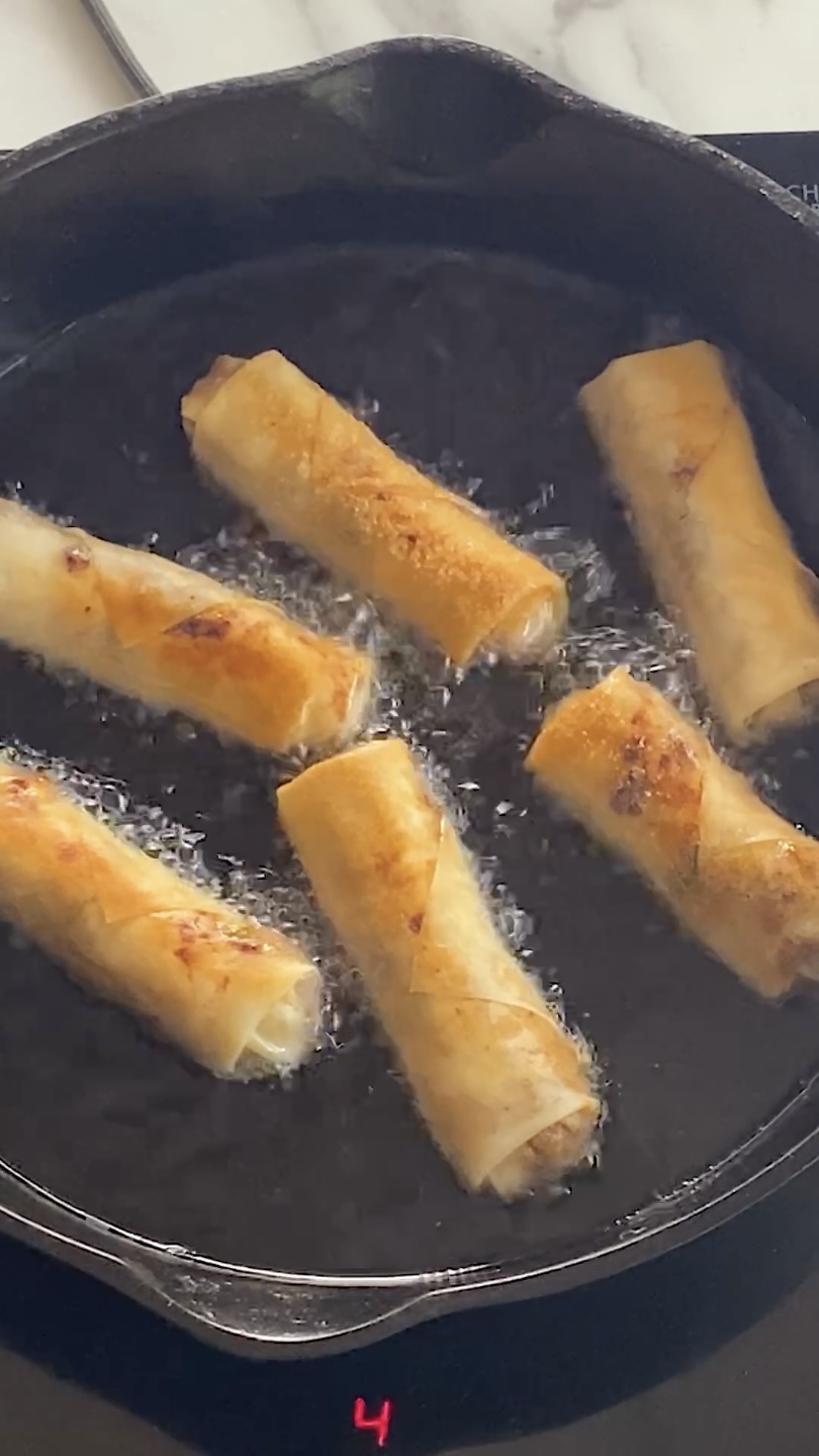 Frying spring rolls on the second side.