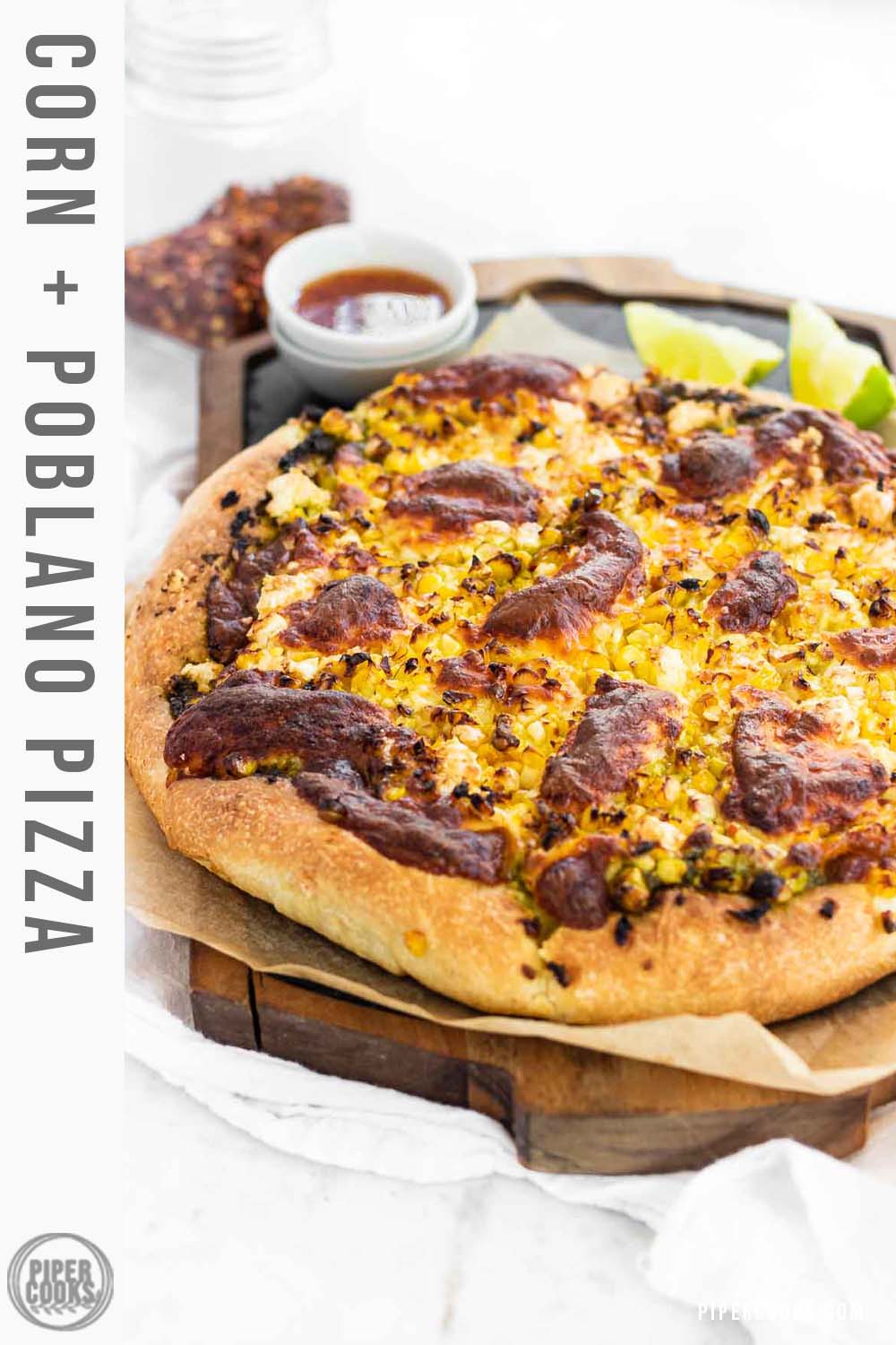 A corn pizza on a slate platter.