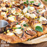 A pizza with figs, goat cheese, and fresh oregano.