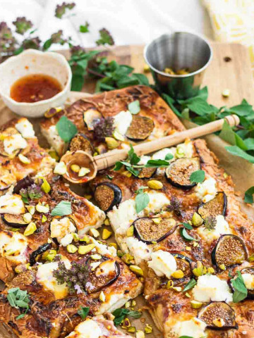 A pizza with figs, goat cheese, and fresh oregano.