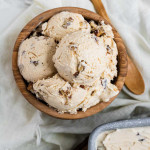 Butter pecan ice with chopped pecans in it in a bowl.