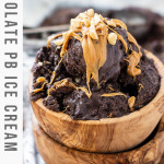 Chocolate peanut butter ice cream in a wooden bowl topped with peanut butter and peanuts.