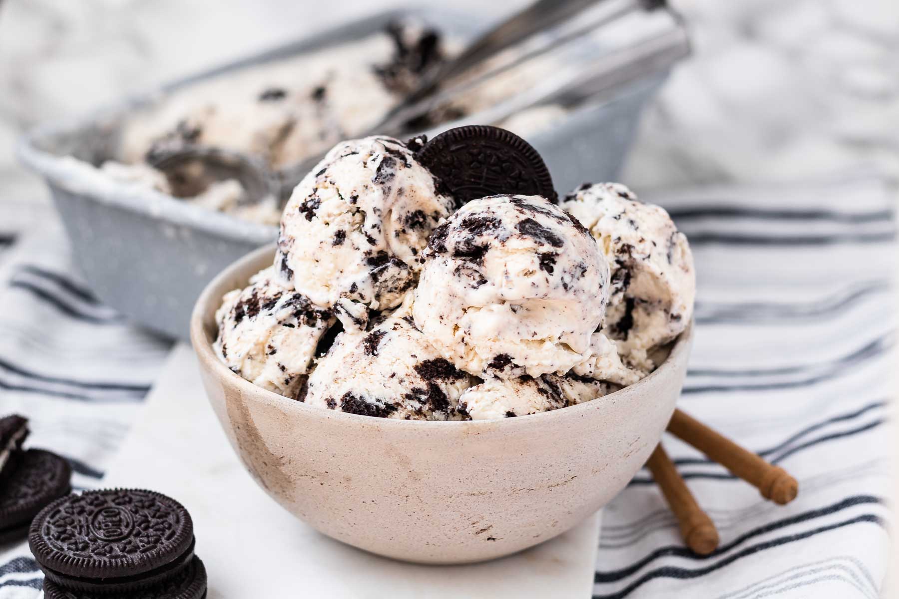 Oreo ice cream in a bowl with an oreo cookie on top.