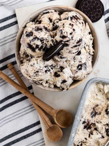 Oreo ice cream in a bowl with an oreo cookie on top.