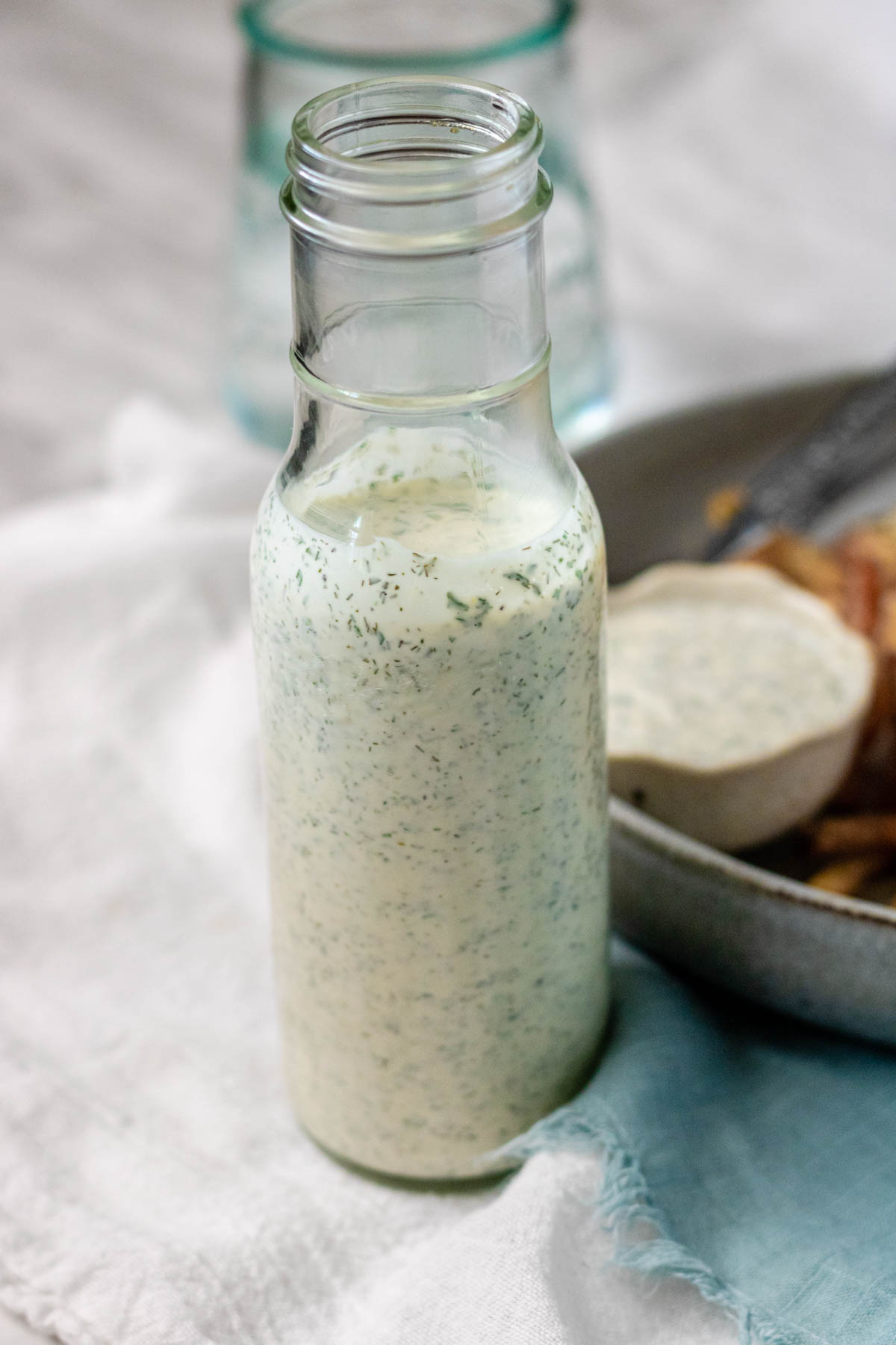 Homemade ranch dressing in a tall glass bottle.