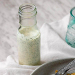 Homemade ranch dressing in a tall glass bottle.