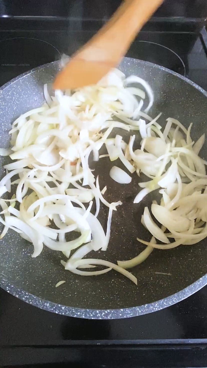 Onions are sauteed in a large skillet.