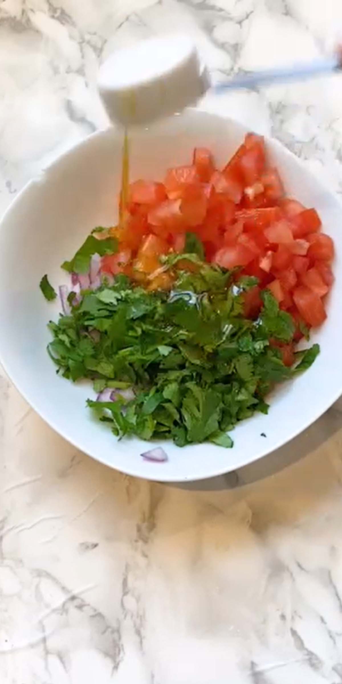 Tomato and cilantro in a bowl.