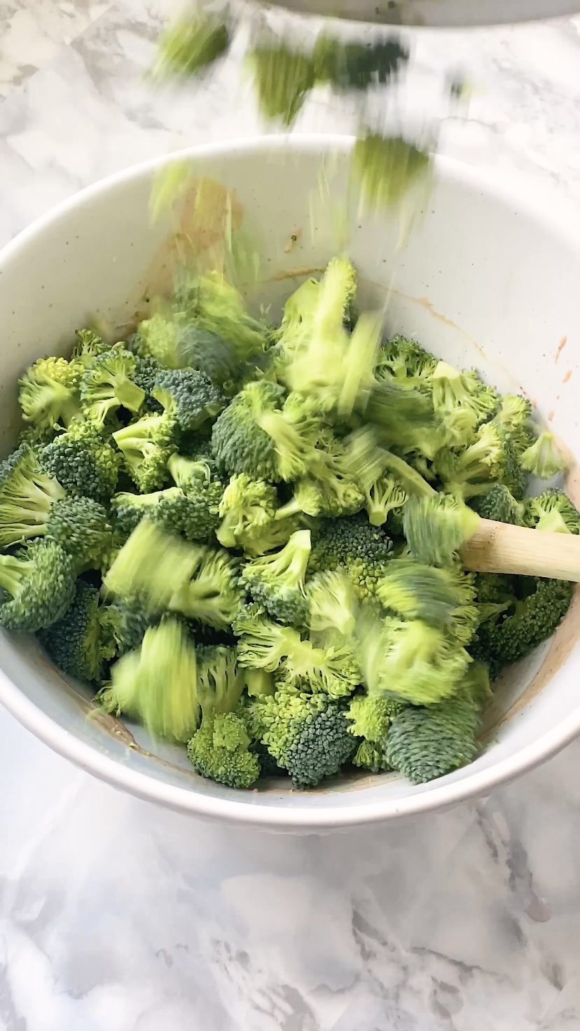 Broccoli is poured into a mixing bowl.