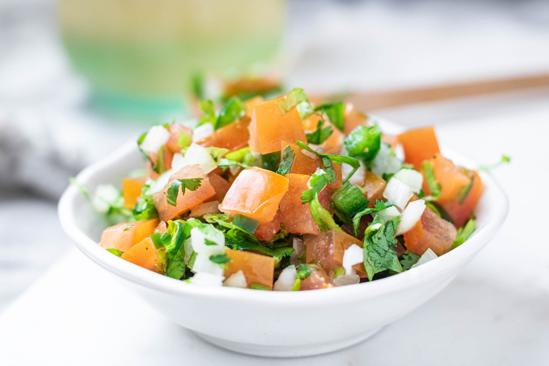 A bowl with fresh diced tomato, onion, jalapeno, and cilantro.
