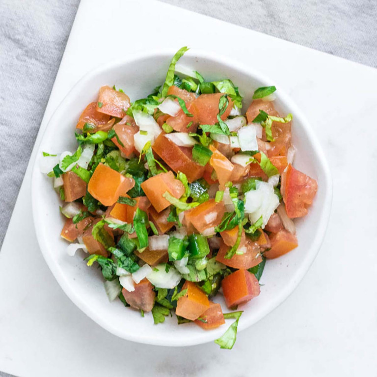 A bowl with fresh diced tomato, onion, jalapeno, and cilantro.