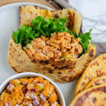Mashed chickpea salad in a pita with lettuce.