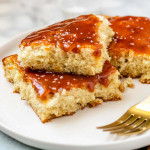 Cake on a plate with caramel sauce on top.