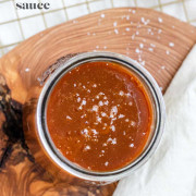 Caramel sauce in a glass with a text title for Pinterest.