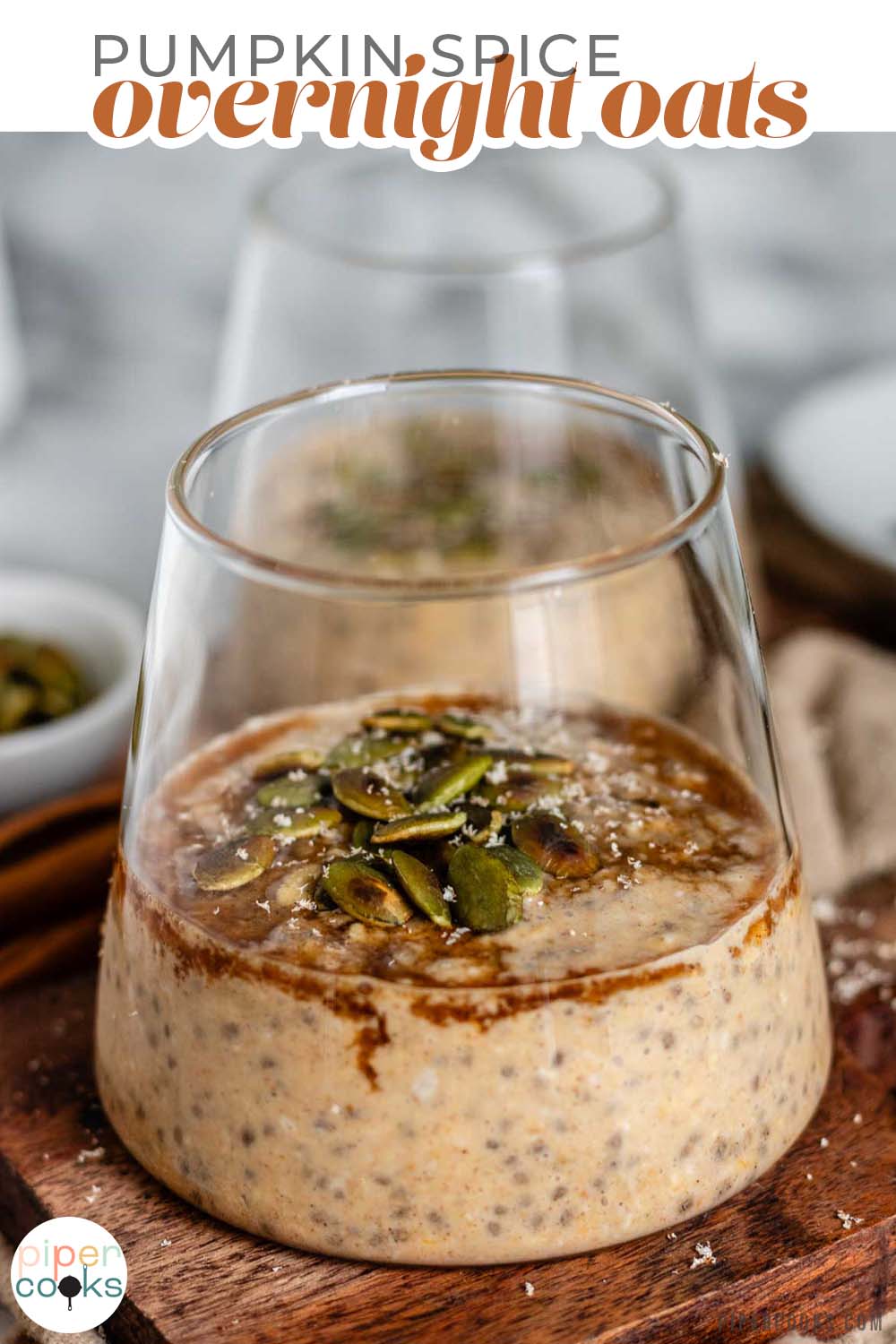 Oats in a glass cup with syrup and pumpkin seeds on top with text title for pinterest.