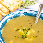 Potato soup in a blue and white bowl.