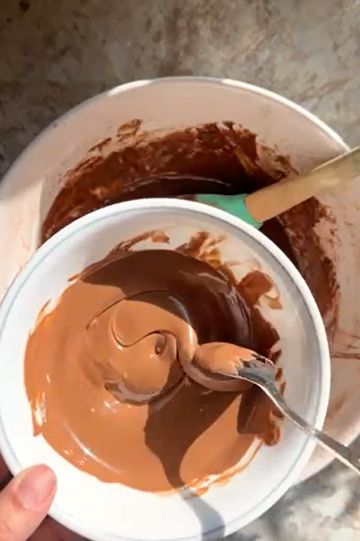 Melted chocolate is stirred.
