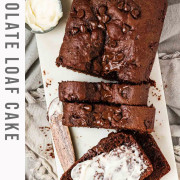 A chocolate loaf cake with one slice buttered with text title for Pinterest.