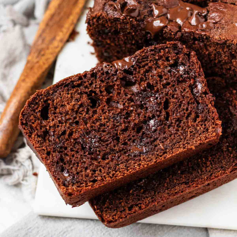 A chocolate loaf cake with slices cut.