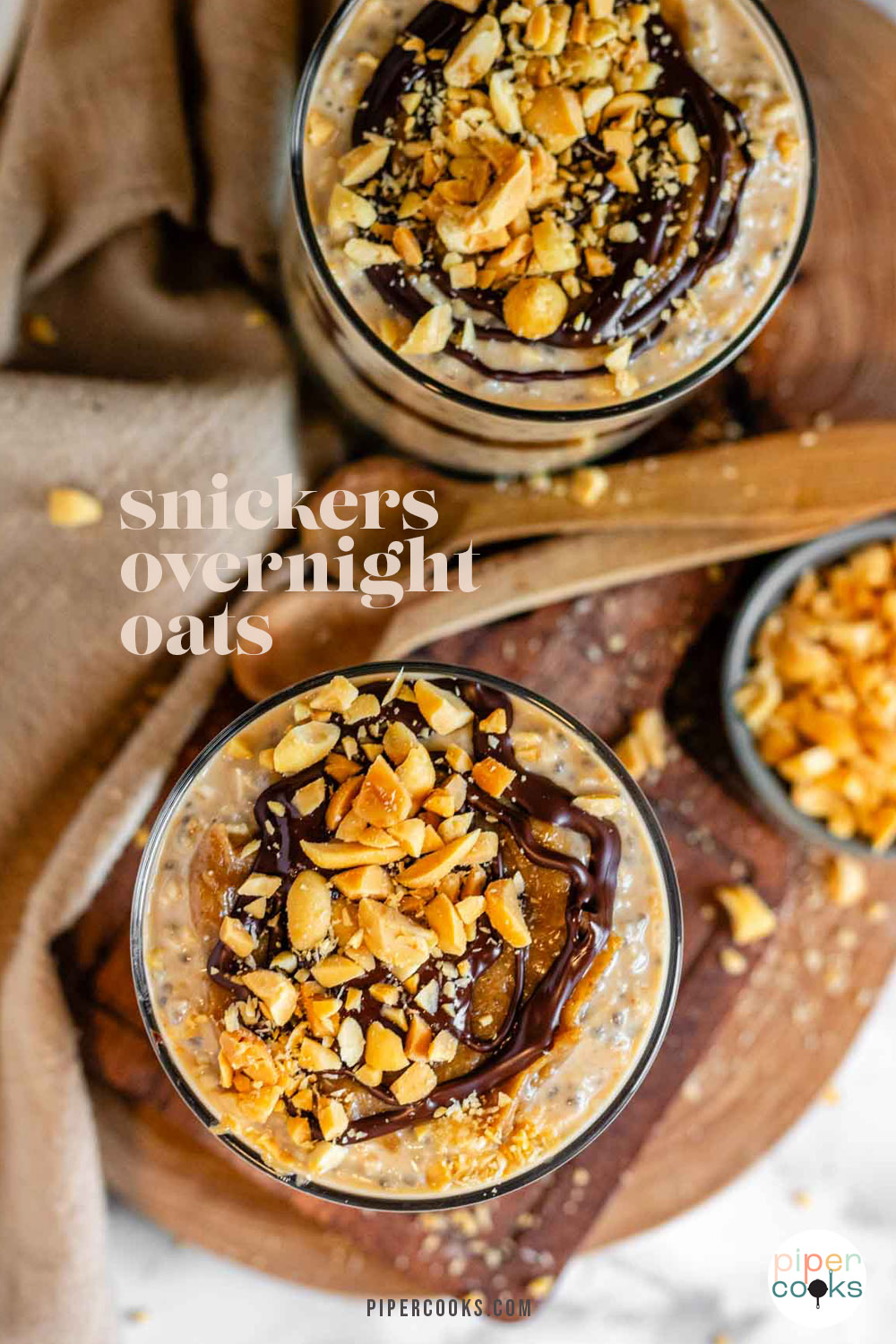 Oats in a glass topped with caramel, chocolate, and peanuts with test for Pinterest.