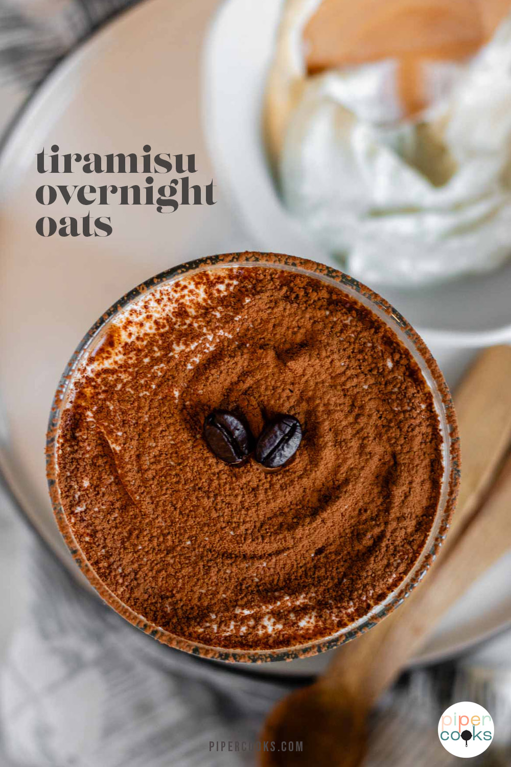 Overnight oats in a glass topped with cocoa powder and two coffee beans with text for Pinterest.