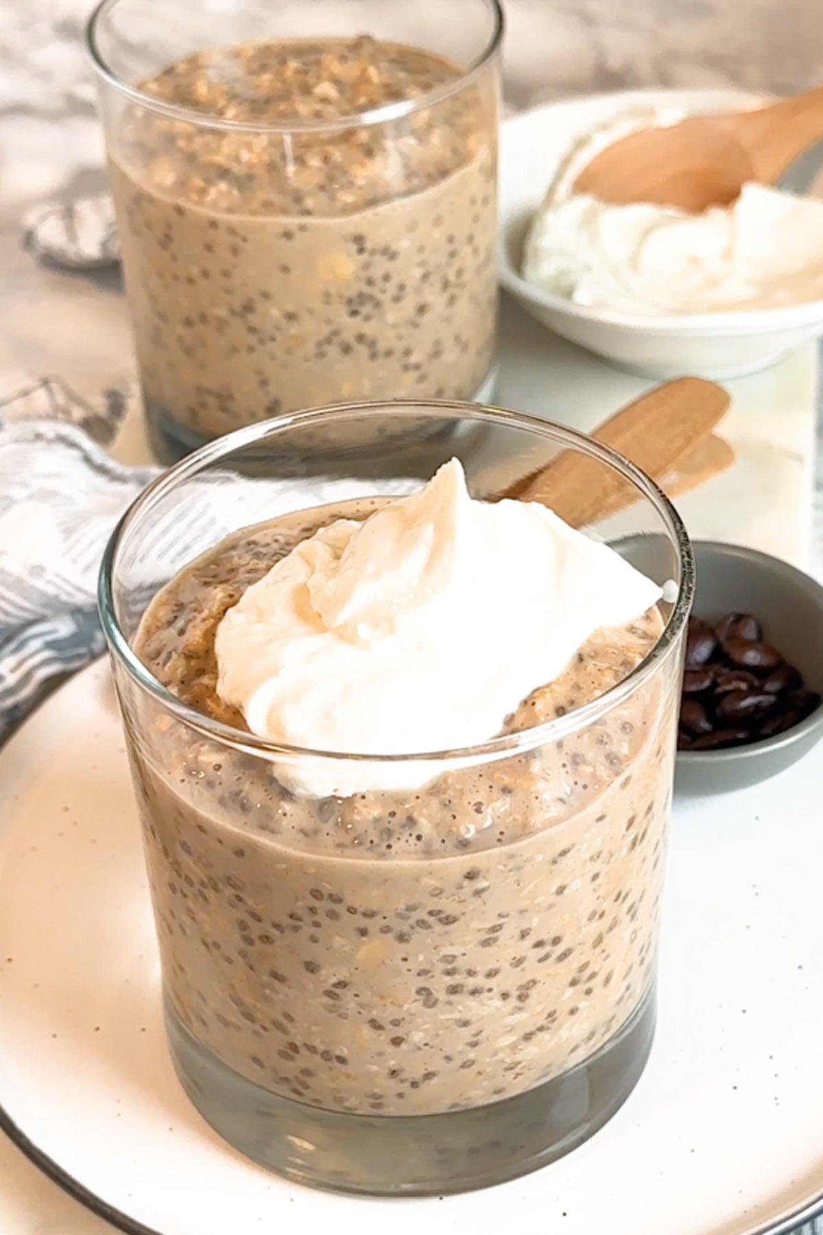 Oats in a glass with a cream cheese topping.