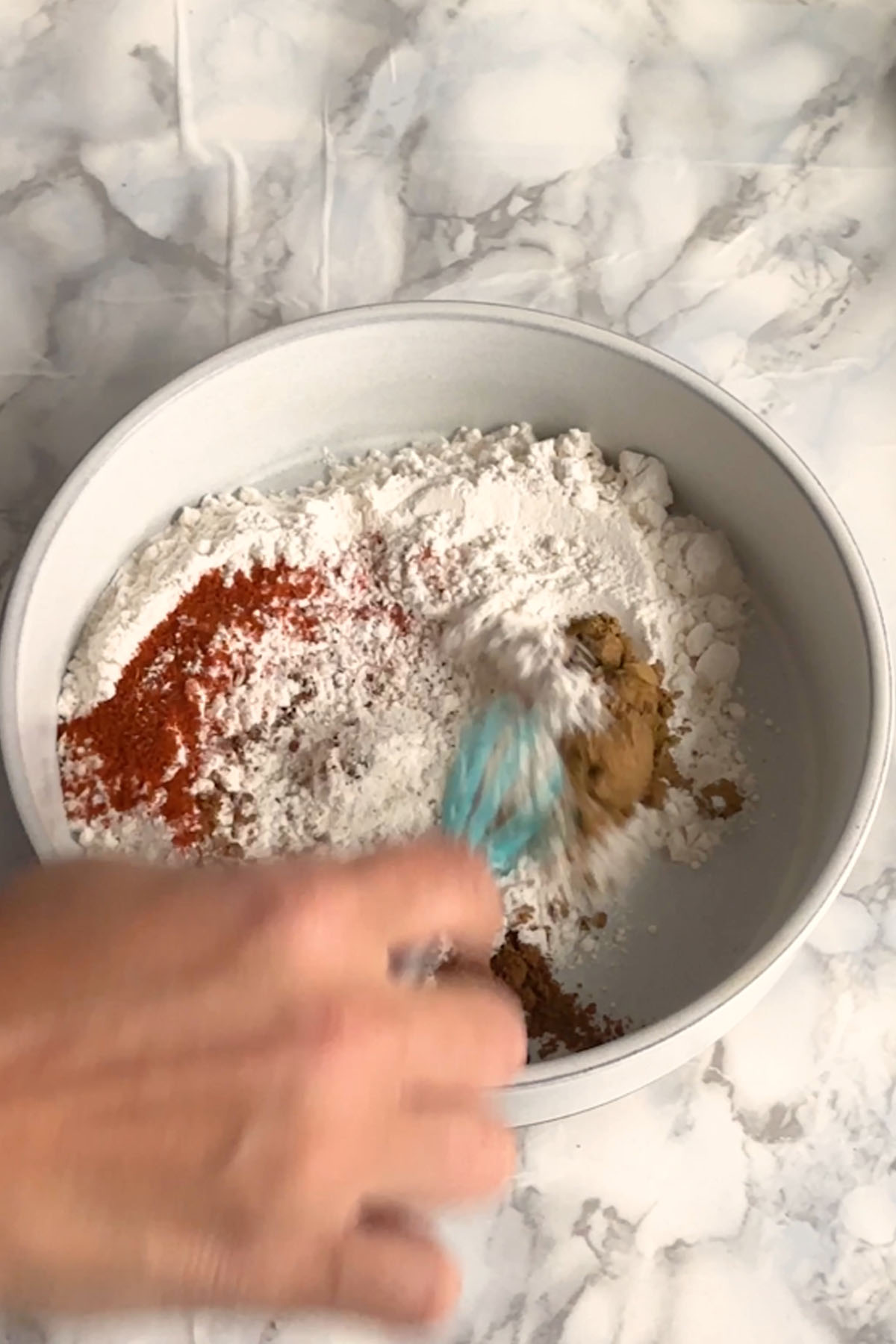 Flour and spices are whisked together.