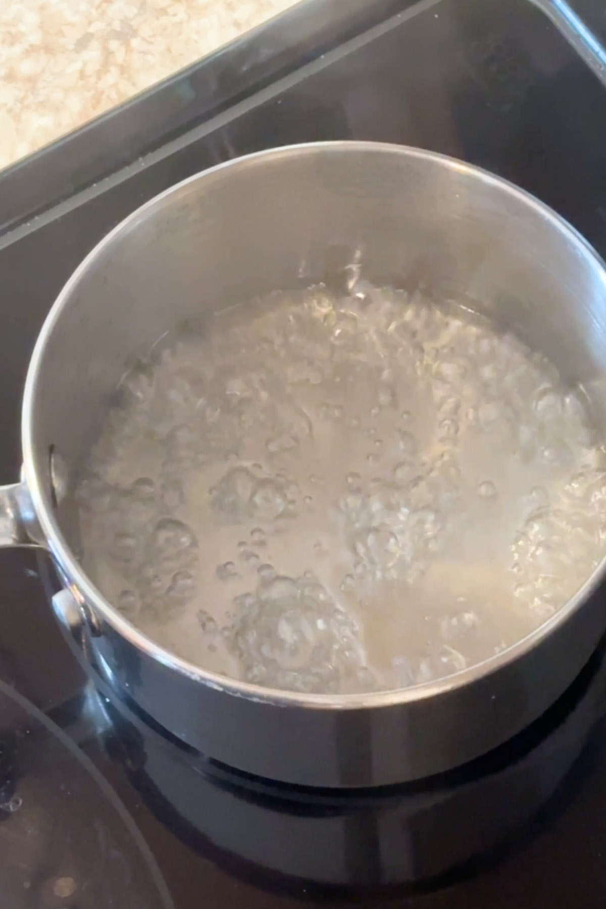 Simple syrup boiling in a pot.