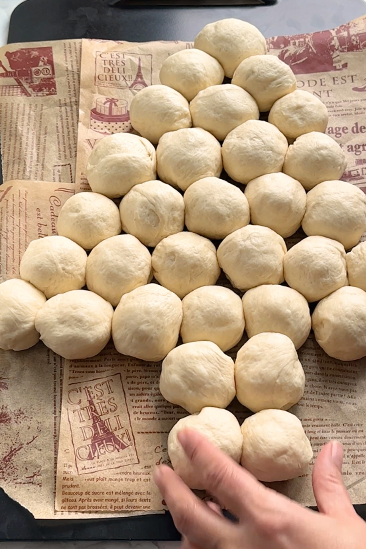Rolls of dough in the shape of a Christmas tree on a baking sheet.