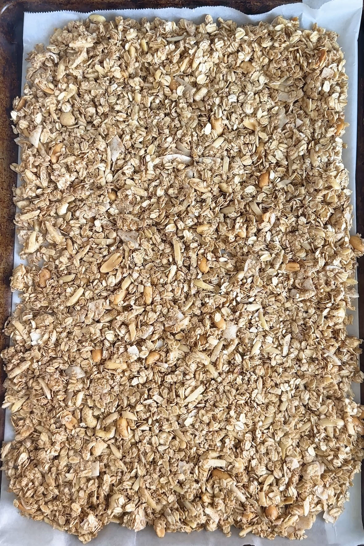 Unbaked granola on a baking sheet.