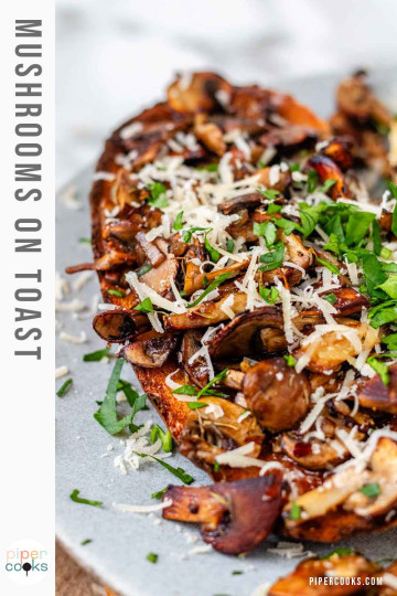 Toast on a plate topped with mushrooms, cheese, and parsley with text for Pinterest.