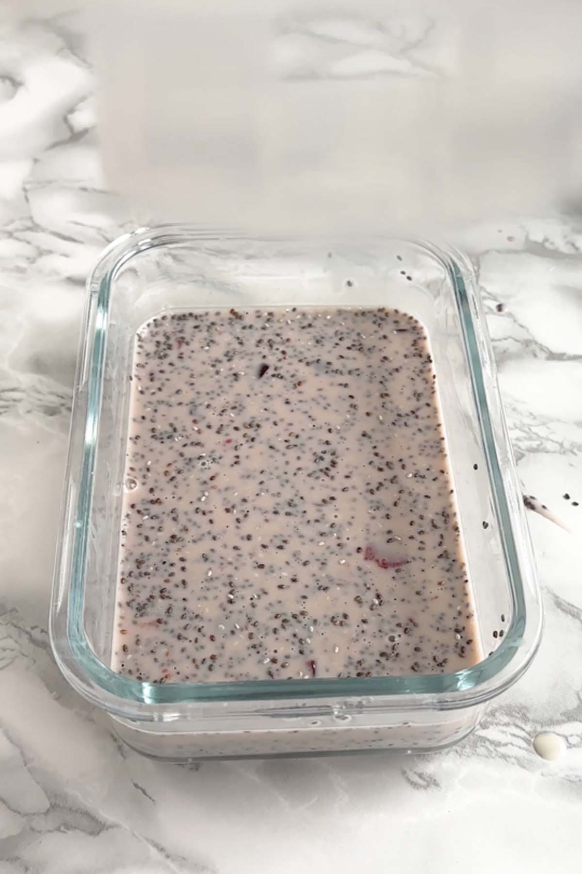 A lid is added to a dish of chia pudding.
