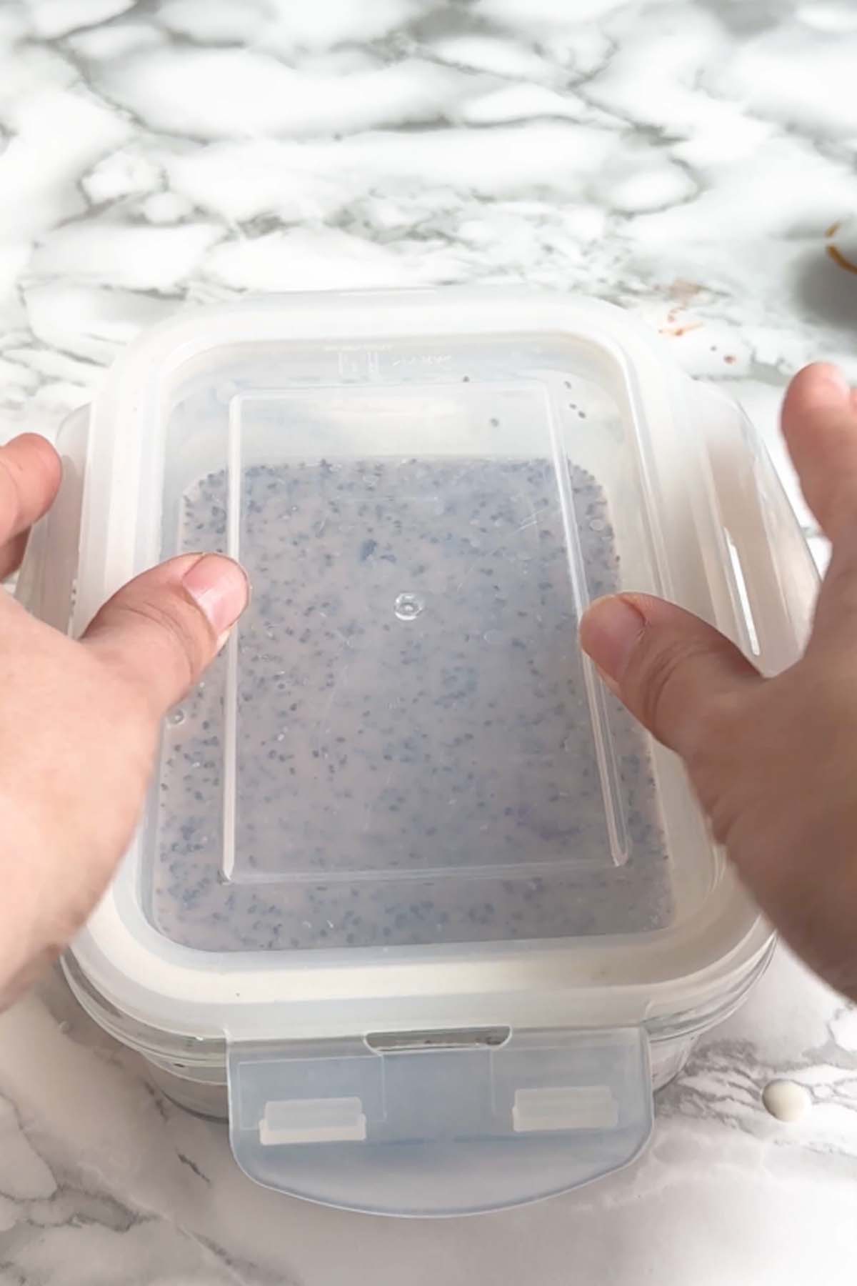 A lid is added to a dish of chia pudding.