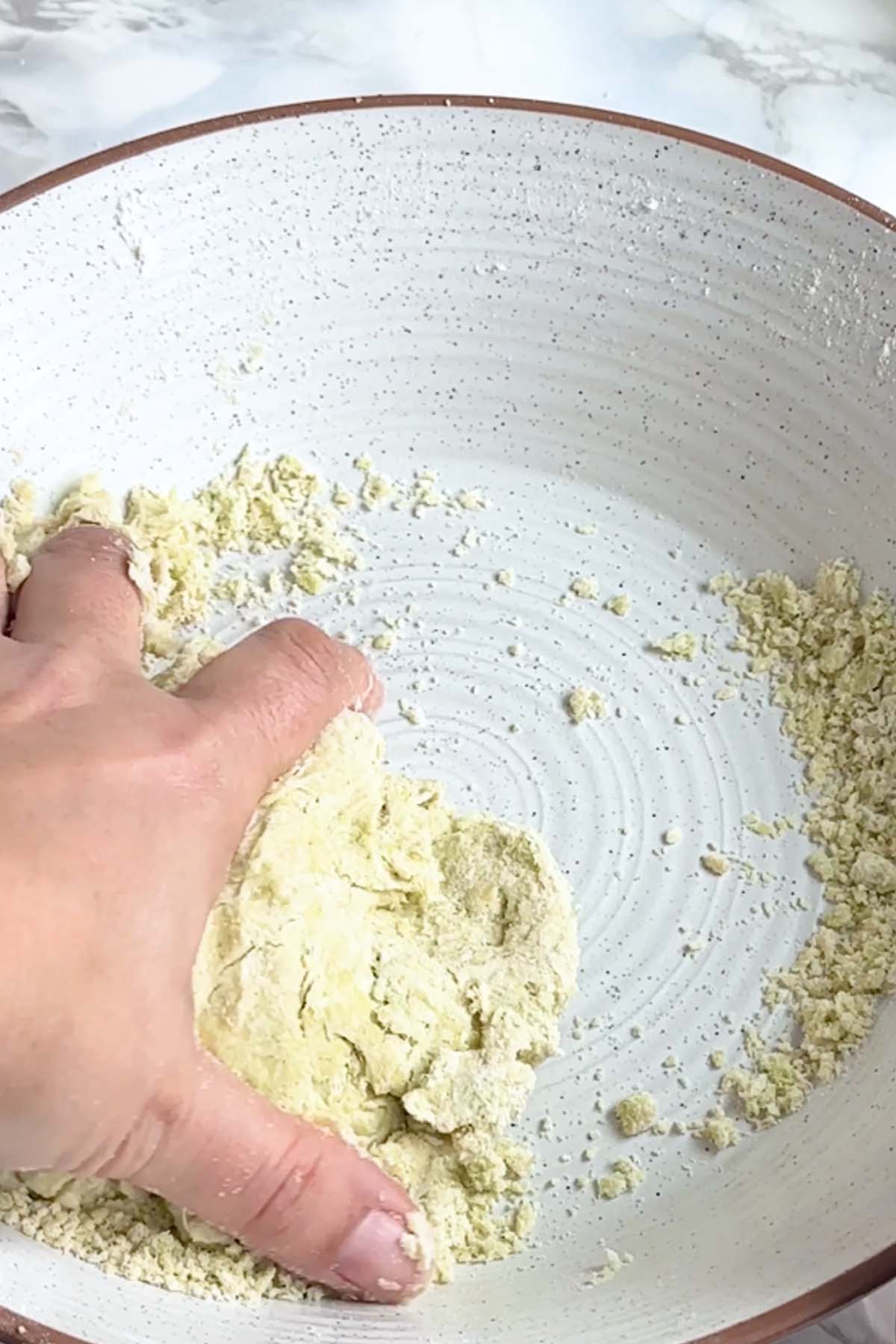 Pie dough is combined by hand.