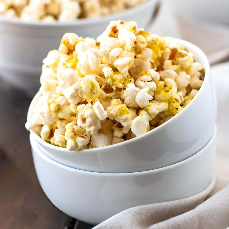 Popcorn in stacked white bowls.