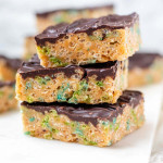 Stacked rice krispie squares with a chocolate topping.