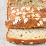Sliced banana bread with oats on top.