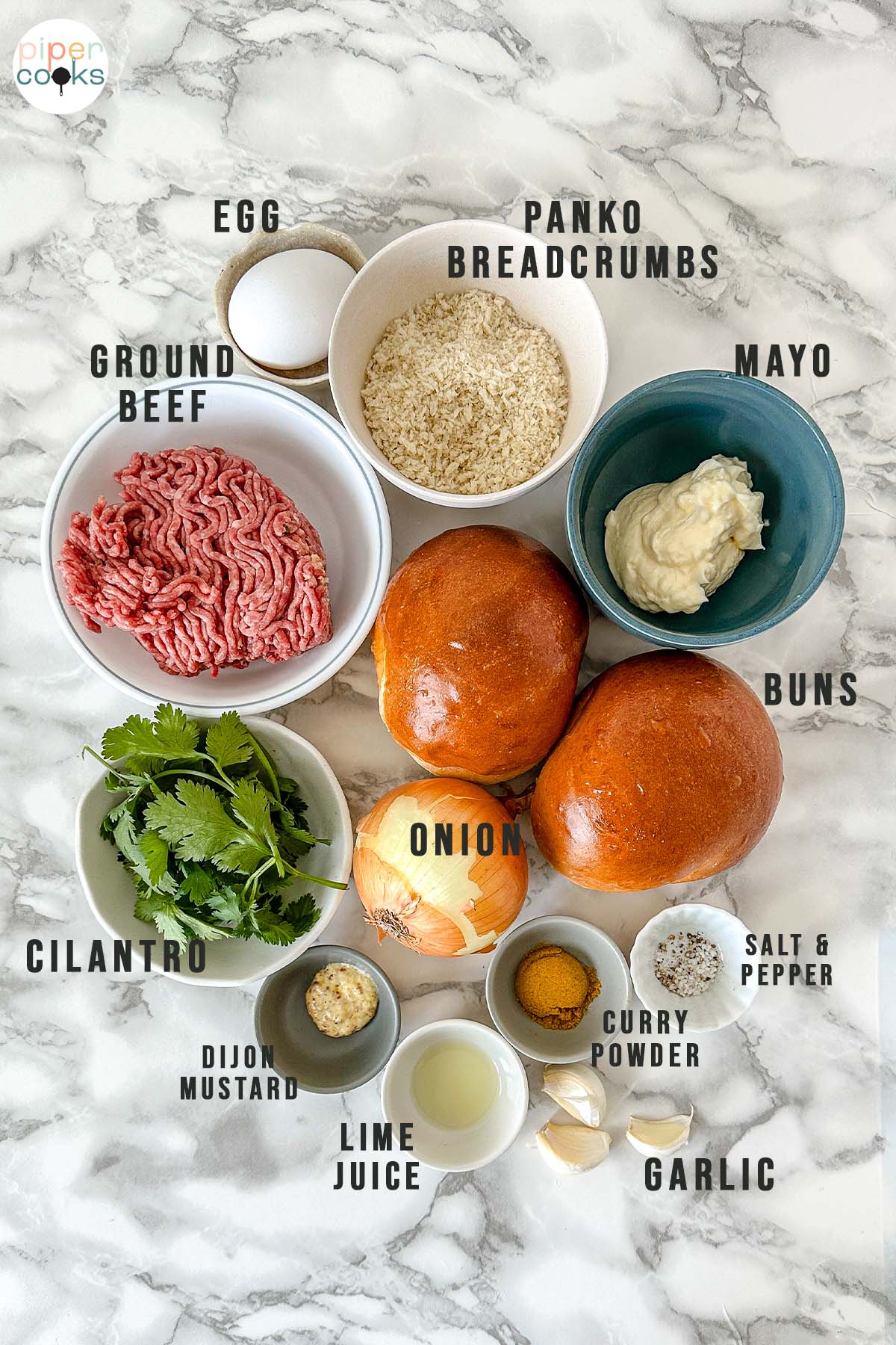 Ingredients for curry burgers, labeled egg, panko breadcrumbs, ground beef, mayo, buns, onion, cilantro, Dijon mustard, lime juice, curry powder, garlic, salt, and pepper.