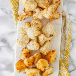 3 types of breaded cooked cauliflower on a white marble slab.