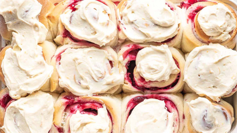 Sweet rolls with pink filling topped with white icing.