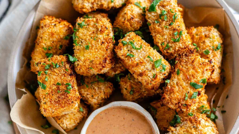 Cooked breaded tofu cubes in a bowl.