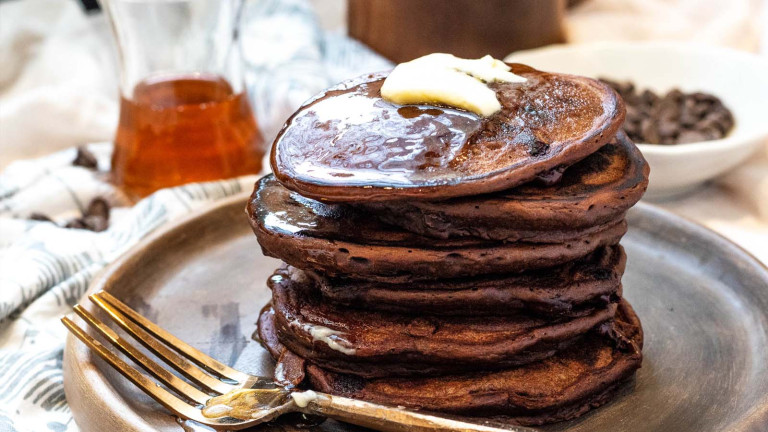 Stacked chocolate pancake on a plate.