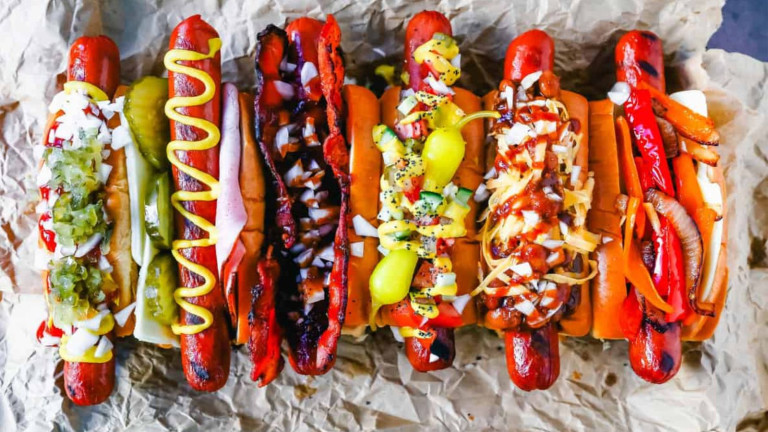6 hot dogs all with different toppings.